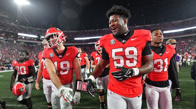 Georgia tight end Brock Bowers (19) and Georgia offensive lineman Bo Hughley (59) celebrate after Georgia beat Mississippi during an NCAA football game at Sanford Stadium, Saturday, November 11, 2023, in Athens. Georgia won 52-17 over Mississippi. (Hyosub Shin / Hyosub.Shin@ajc.com)