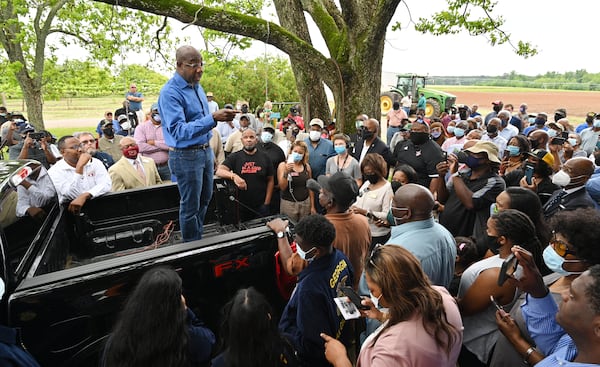 U.S. Sen. Raphael Warnock speaks to supporters in May at a gathering of Black farmers in Byromville. For now, Democrats have chosen to avoid attacking Herschel Walker, who could challenge Warnock in next year's Senate race. Instead, they continue to focus on issues that helped the party sweep January's Senate runoffs. (Hyosub Shin / Hyosub.Shin@ajc.com)