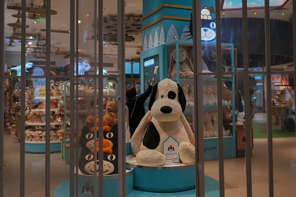 A staff member wipes a shelf at the American toy store FAO Schwarz before it opens business at a popular shopping mall in Beijing, Friday, May 9, 2025. (AP Photo/Andy Wong)