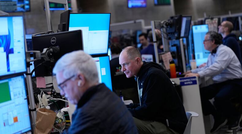Traders work on the floor at the New York Stock Exchange in New York, Friday, Jan. 9, 2026. (AP Photo/Seth Wenig)