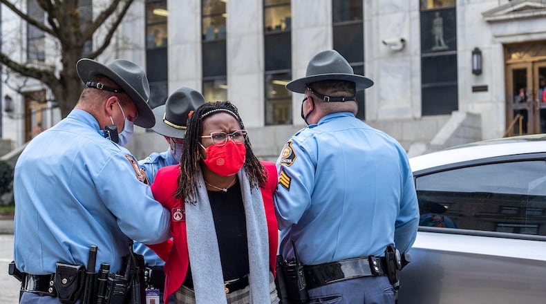 Rep. Park Cannon (D-Atlanta) is placed into the back of a Georgia State Capitol patrol car after being arrested by Georgia State Troopers on day 38 of the legislative session at the Georgia State Capitol Building in Atlanta, Thursday, March 25, 2021. (Alyssa Pointer/Atlanta Journal-Constitution/TNS)