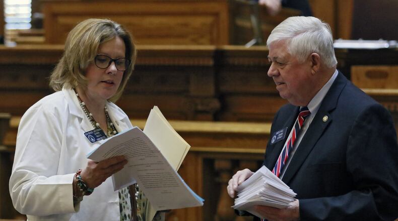 Georgia Sen. Renee Unterman, R-Buford, confers with Sen. Jack Hill on the floor of the Senate. BOB ANDRES /BANDRES@AJC.COM