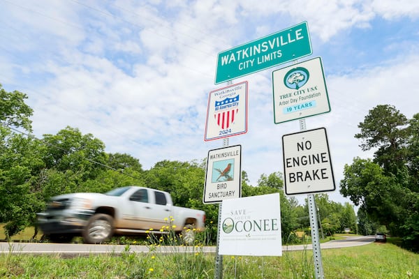 A 'Save South Oconee' sign stands at Watkinsville's city limits on Thursday, May 29, 2026.  Opponents of a proposed highway bypass have garnered around 2,500 signatures. (Miguel Martinez/AJC)