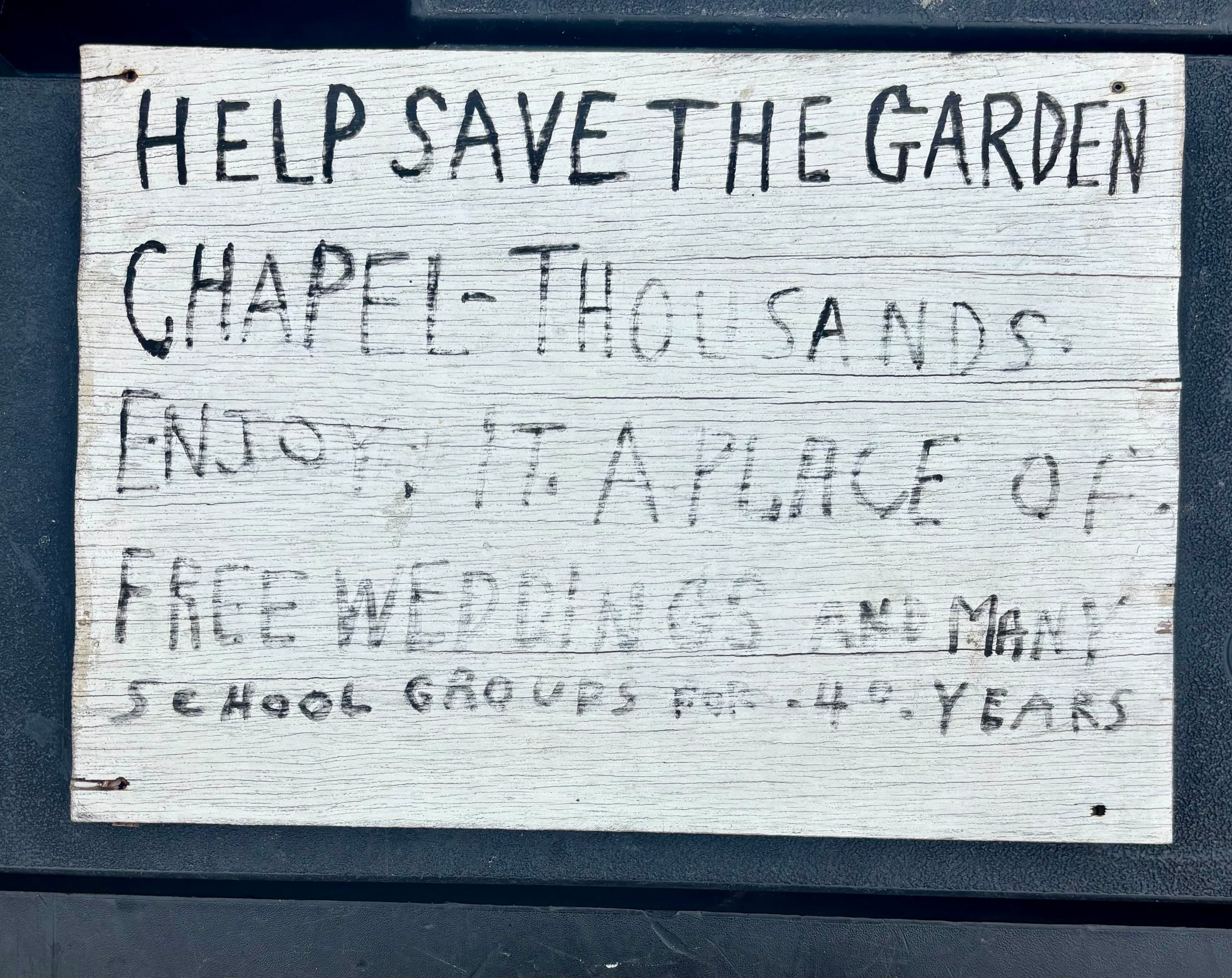 The back of a sign that hung on the front door of Howard Finster's World's Folk Art Church. The back of the sign urged the reader to help save the church. It remained closed for more than 25 years. Courtesy of Eddy Willingham