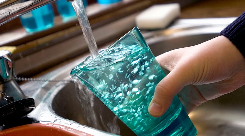 Child filling glass with tap water UK. (Photo by Photofusion/Universal Images Group via Getty Images)