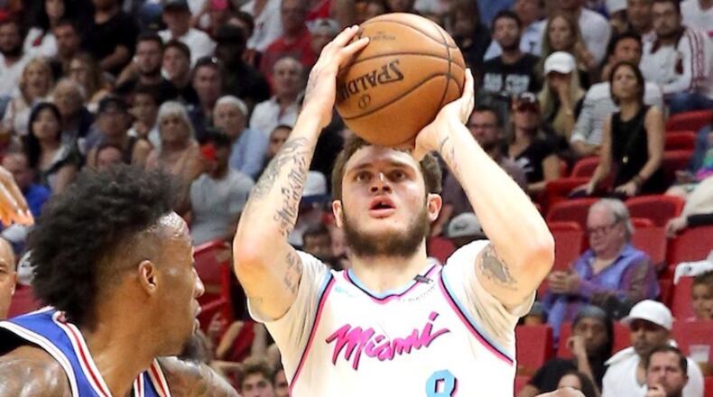 The Miami Heat's Tyler Johnson looks to shoot over the Philadelphia 76ers' Robert Covington at the AmericanAirlines Arena in Miami, on February 27, 2018. (Charles Trainor Jr./Miami Herald/TNS)