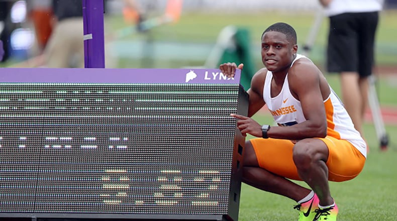 Christian Coleman poses next to his record-time scoreboard during the NCAA track and field championships at Hayward Field in Eugene, Oregon. Photo By Donald Page/Tennessee Athletics
