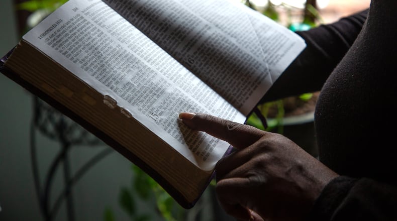 A client of the federal Housing Opportunities for Persons with AIDS program reads her mother's bible at the Ellenwood house where she was staying Sunday, December 23, 2021. She is homeless after her case fell through the cracks of the city of Atlanta-run program. STEVE SCHAEFER FOR THE ATLANTA JOURNAL-CONSTITUTIONSTEVE SCHAEFER FOR THE ATLANTA JOURNAL-CONSTITUTION