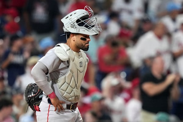 Boston Red Sox catcher Carlos Narváez waits for umpires to call catcher's interference on him during an at-bat by Philadelphia Phillies' Edmundo Sosa with the bases loaded during the 10th inning of a baseball game Monday, July 21, 2025, in Philadelphia. (AP Photo/Matt Slocum)