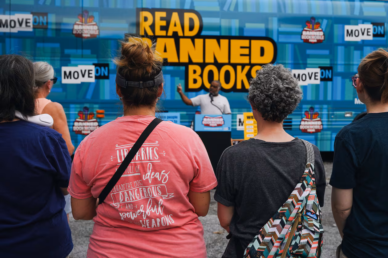 Erick Allen, former state representative and chair of Cobb County Democrats, speaks to visitors at the Marietta stop of the Banned Bookmobile Tour in 2023. (Olivia Bowdoin for the AJC)