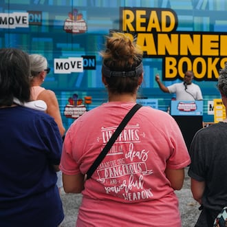Erick Allen, former state representative and chair of Cobb County Democrats, speaks to visitors at the Marietta stop of the Banned Bookmobile Tour in 2023. (Olivia Bowdoin for the AJC)