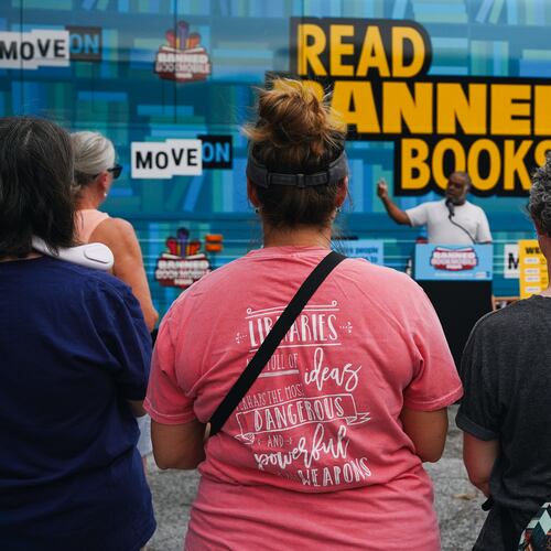 Erick Allen, former state representative and chair of Cobb County Democrats, speaks to visitors at the Marietta stop of the Banned Bookmobile Tour in 2023. (Olivia Bowdoin for the AJC)