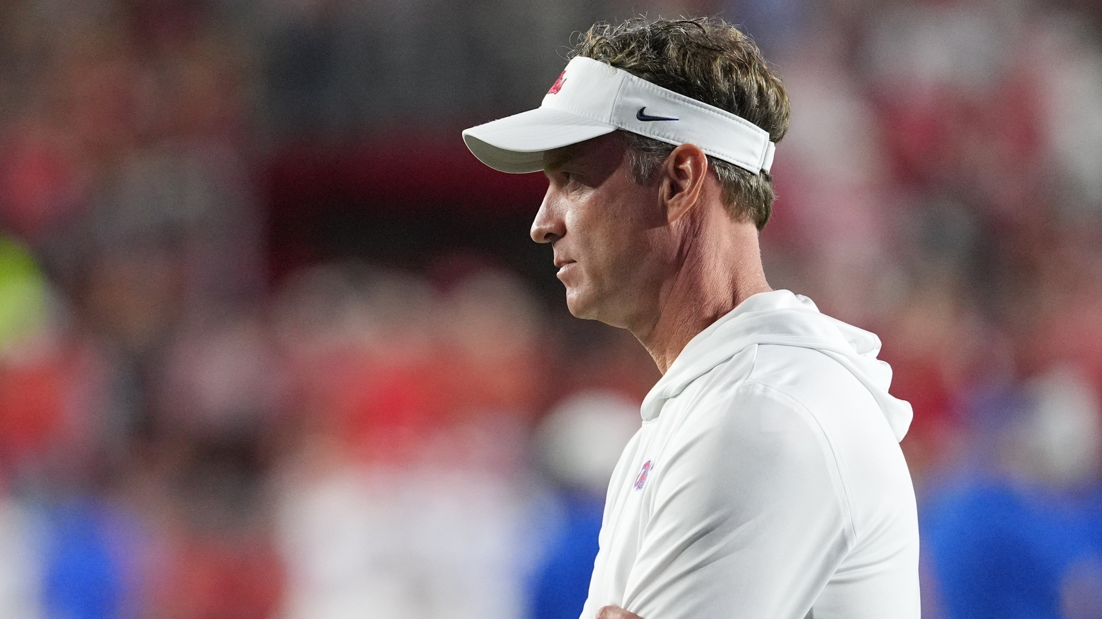 Mississippi head coach Lane Kiffin, watches his team warm up prior to the start of an NCAA college football game against Florida, Saturday, Nov. 15, 2025, in Oxford, Miss. (AP Photo/Rogelio V. Solis)