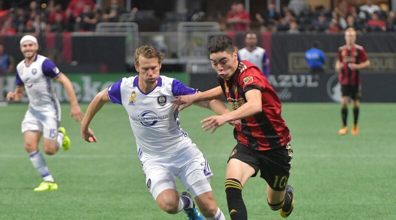 Orlando City SC defender Jonathan Spector (2) challenges Atlanta United midfielder Miguel Almiron (10) in the second half of an MLS soccer match at the Mercedes-Benz Stadium on Saturday, September 16, 2017. HYOSUB SHIN / HSHIN@AJC.COM