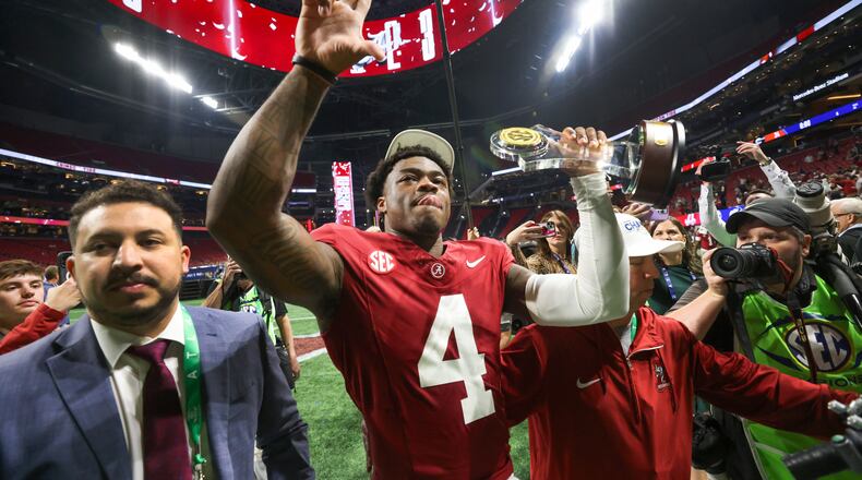 Alabama Crimson Tide quarterback and Most Valuable Player Jalen Milroe (4) celebrates as he walks from the field following the SEC Championship game at Mercedes-Benz Stadium in Atlanta, on Saturday, December 2, 2023. Alabama defeated Georgia 27-24 to end the Bulldogs’ 29-game win streak. (Jason Getz / Jason.Getz@ajc.com)