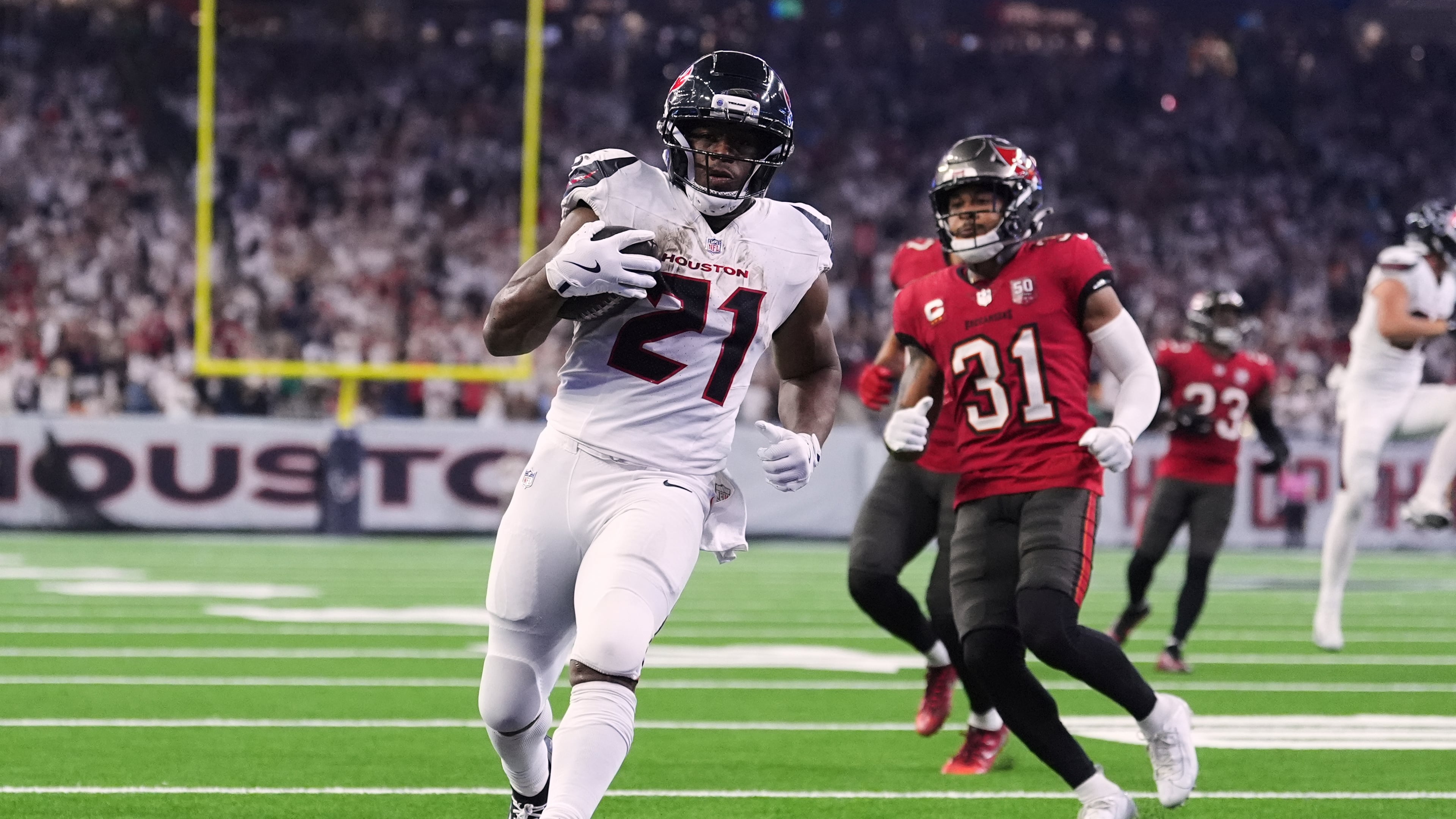 Texans running back Nick Chubb (center) runs for a touchdown past the Buccaneers' Antoine Winfield Jr. in the second half Monday, Sept. 15, 2025, in Houston. Chubb has 25 carries for 104 yards this season after missing much of last year with a broken foot. (Eric Gay/AP)