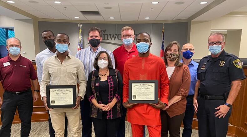 Holding their awards are (l-r) Tyree Thorne and Kirk Malcolm, with Dunwoody Mayor Lynn Deutsch standing between them. (Courtesy of Dunwoody)