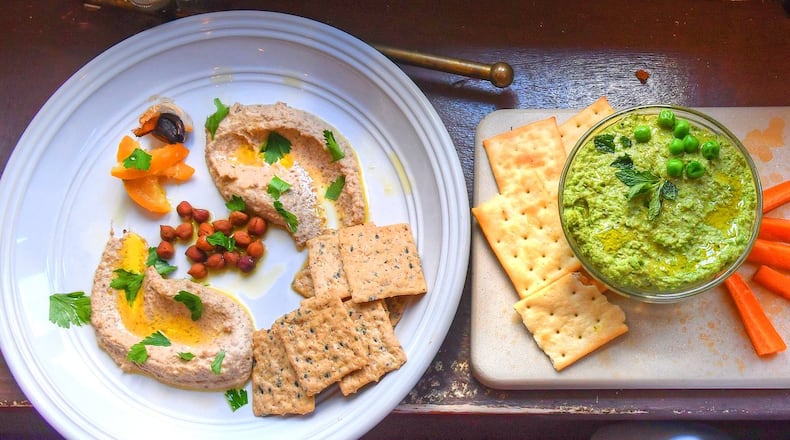 Add some flair to those meals at home with Black Chickpea Hummus with Black Garlic and Preserved Lemon (from left), Sweet Pea and Sun Butter Hummus, and Wisteria’s Black-Eyed Pea Hummus. STYLING BY SUSAN PUCKETT AND JASON HILL / CONTRIBUTED BY CHRIS HUNT PHOTOGRAPHY