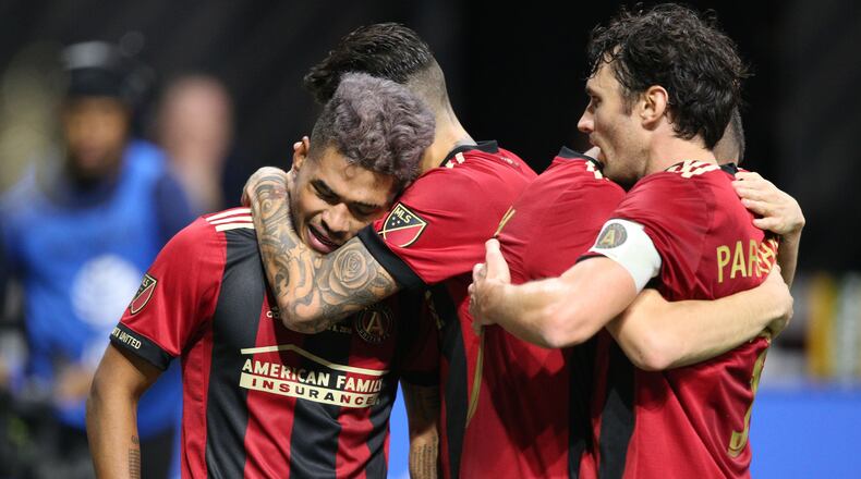 Atlanta United team mates congratulate Atlanta United forward Josef Martinez (7) after he scored a goal in the first half, including Michael Parkhurst (right). The Atlanta United soccer team plays the Portland Timbers for the MLS Cup, the championship game of the Major League Soccer League at Mercedes-Benz Stadium in Atlanta. CURTIS COMPTON / CCOMPTON@AJC.COM