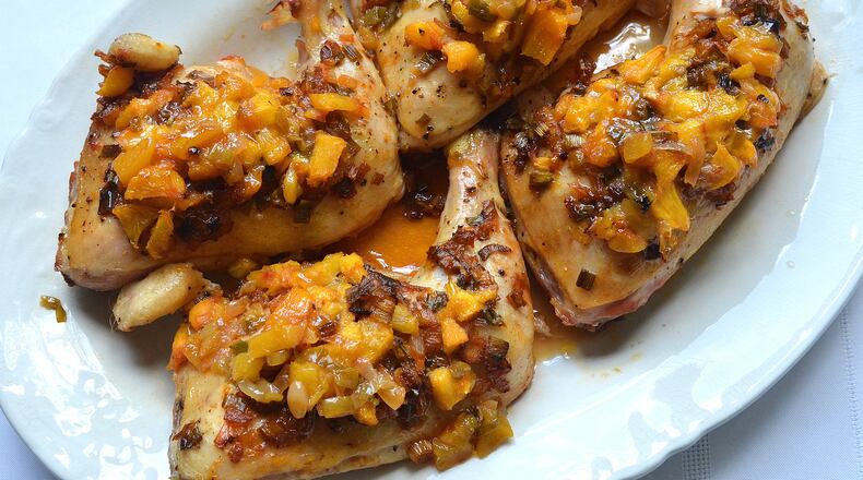 160711 Atlanta, Georgia: Dori Sanders' Bourbon-Laced Tipsy Chicken With Peaches. This easy baked-chicken recipe is dressed up with chopped peaches and a splash of bourbon. It's from "Dori Sanders' Country Cooking" (Algonquin, $15.95), by the South Carolina novelist who runs a peach stand at her family's farm in Filbert, S.C. "It is so good. It is almost literally to die for," Sanders says. For AJC story on peaches . Georgia is the Peach State, but South Carolina produces three times as many. Whose are better, and why? All photos taken Monday July 11, 2016 at the home of Wendell Brock. Styling by Wendell Brock. (Photo by Chris Hunt/Special) for story 072116peaches