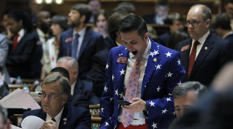 Georgia House members wait well past midnight Thursday to see what the state Senate would do on an adoption bill, including state Rep. David Clark, R-Buford, dressed in patriotic colors. BOB ANDRES /BANDRES@AJC.COM