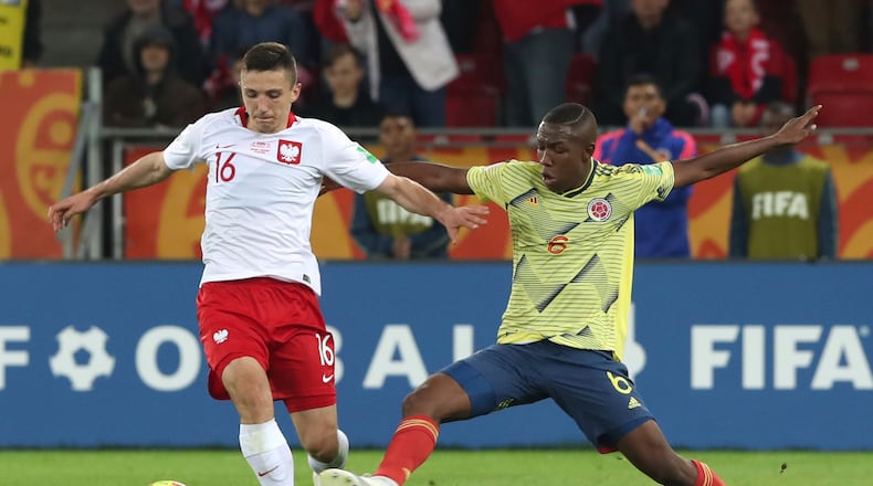 Poland's Bartosz Slisz, left, and Colombia's Andres Perea challenge for the ball during the Group A U20 World Cup soccer match between Poland and Colombia in Lodz, Poland, Thursday, May 23, 2019. (AP Photo/Czarek Sokolowski)