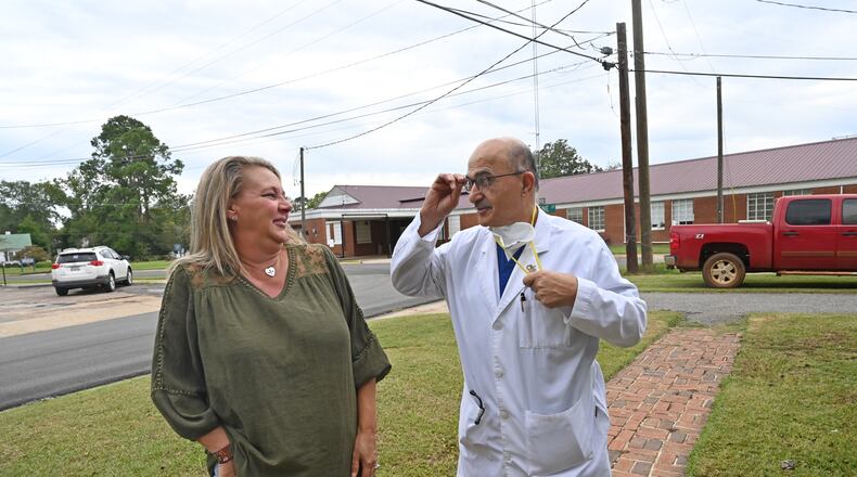 Laura Wiggins greets Dr. Abdollatif Saleh Ghiathi outside his office across from Southwest Georgia Regional Medical Center (background) in Cuthbert. Wiggins had a heart attack and was treated by Dr. Ghiathi at the hospital, which is closing in October. (Hyosub Shin / Hyosub.Shin@ajc.com)