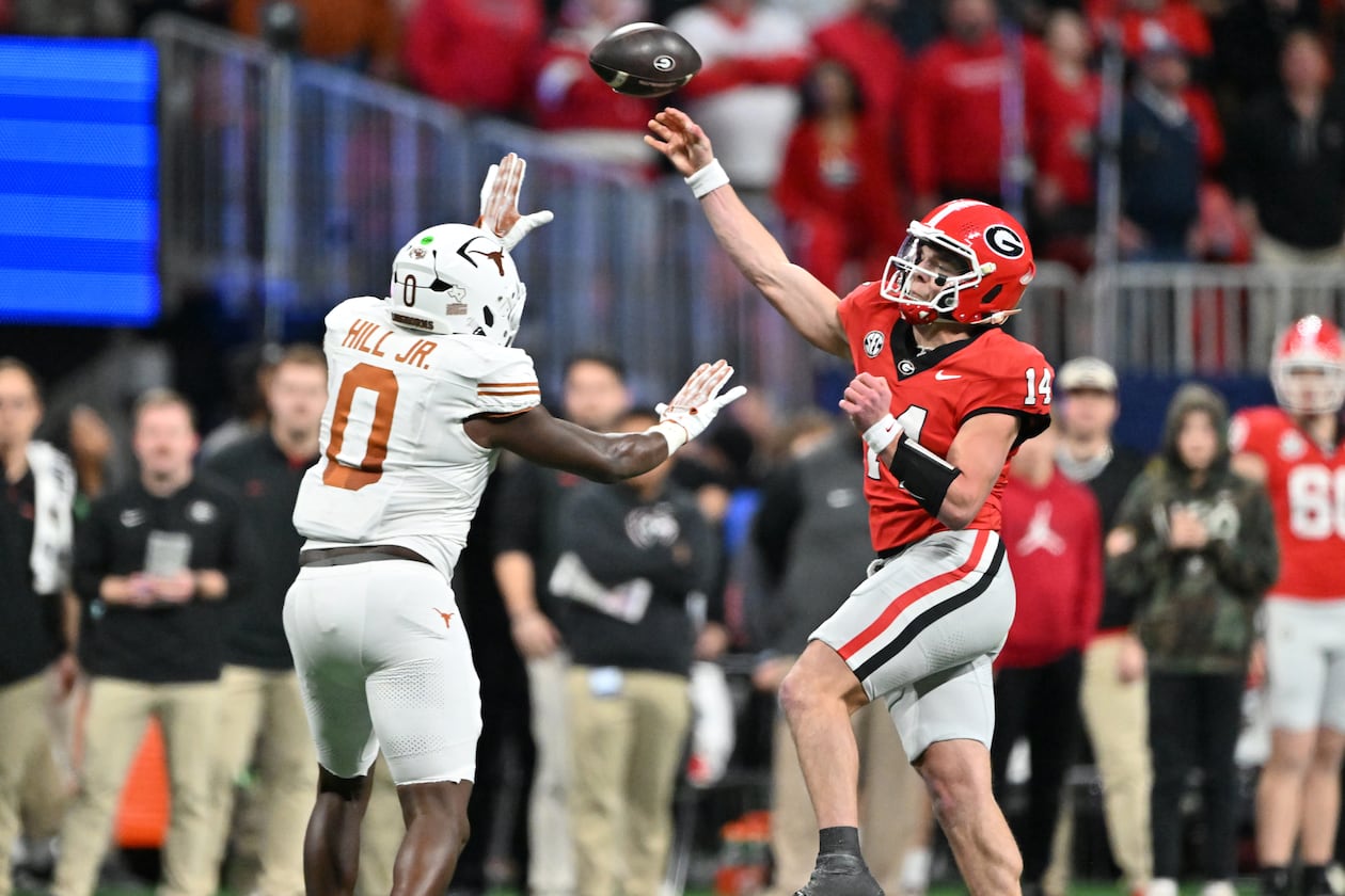 Georgia quarterback Gunner Stockton throws a pass over Texas linebacker Anthony Hill Jr. during the second half in the SEC Championship football game at the Mercedes-Benz Stadium, Saturday, Dec. 7, 2024, in Atlanta. (Hyosub Shin/AJC)