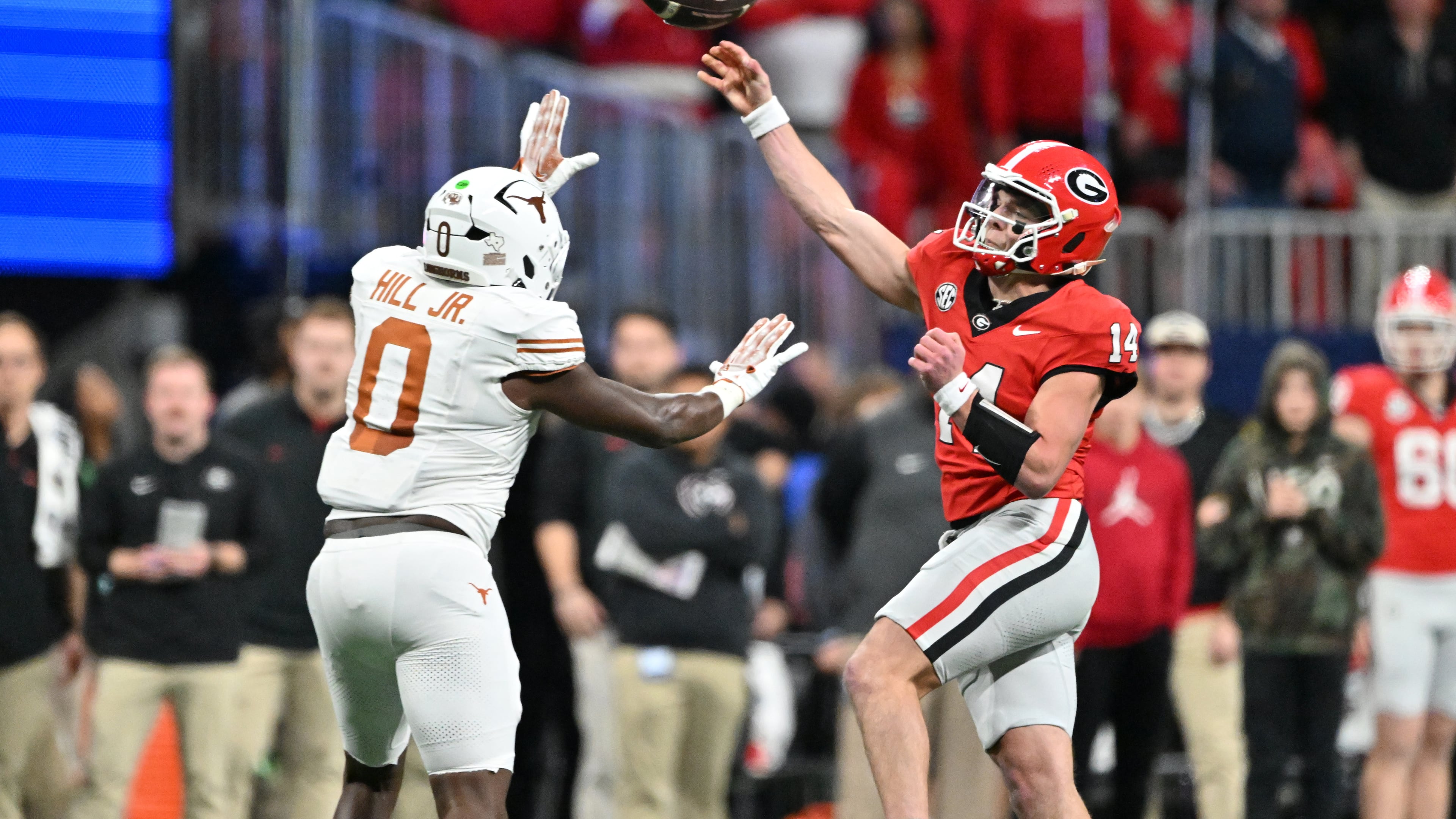 Georgia quarterback Gunner Stockton throws a pass over Texas linebacker Anthony Hill Jr. during the second half in the SEC Championship football game at the Mercedes-Benz Stadium, Saturday, Dec. 7, 2024, in Atlanta. (Hyosub Shin/AJC)
