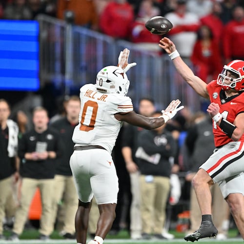 Georgia quarterback Gunner Stockton (14) throws a pass over Texas linebacker Anthony Hill Jr. (0) during the second half in the SEC Championship football game at the Mercedes-Benz Stadium, Saturday, December 7, 2024, in Atlanta. Georgia won 22-19 over Texas in overtime. (Hyosub Shin / AJC)