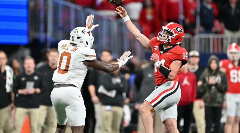 Georgia quarterback Gunner Stockton throws a pass over Texas linebacker Anthony Hill Jr. during the second half in the SEC Championship football game at the Mercedes-Benz Stadium, Saturday, Dec. 7, 2024, in Atlanta. (Hyosub Shin/AJC)