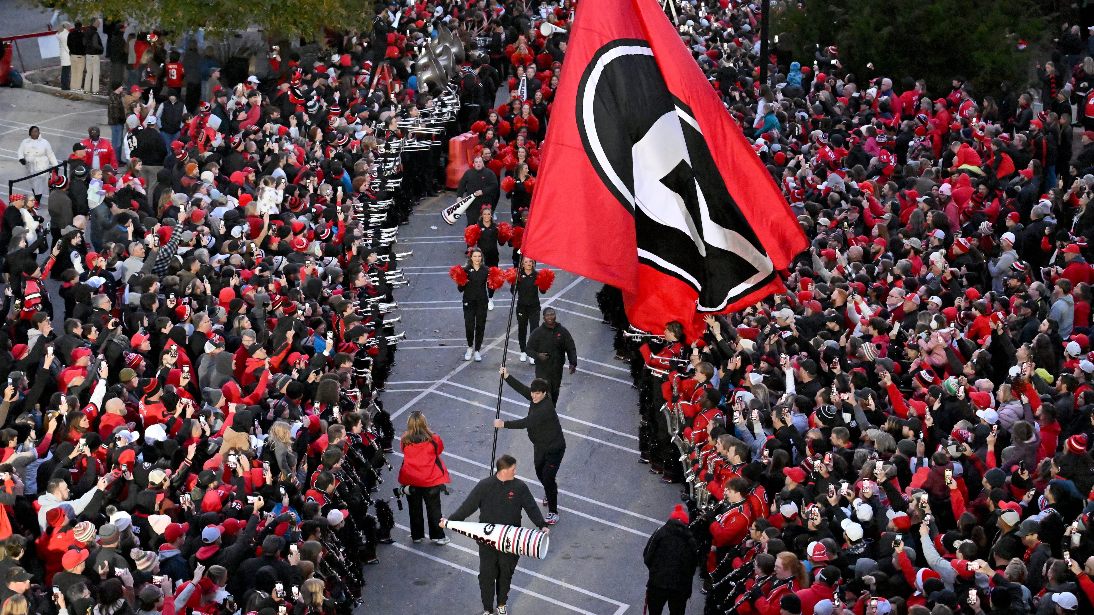 Georgia fans cheer as players and staff arrive during Dawgs Walk before an NCAA football game between Georgia and Georgia Tech at Sanford Stadium, Friday, November 29, 2024, in Athens. (Hyosub Shin / AJC)