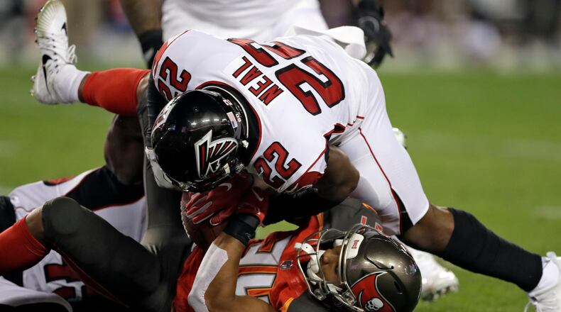 Atlanta Falcons strong safety Keanu Neal (22) takes down Tampa Bay Buccaneers running back Charles Sims (34) after a short reception during the first half of an NFL football game Monday, Dec. 18, 2017, in Tampa, Fla. (AP Photo/Chris O'Meara)