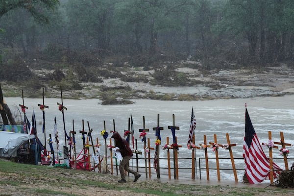 Rain falls over a make-shift memorial for flood victims along the Guadalupe River, Sunday, July 13, 2025, in Kerrville, Texas. (AP Photo/Eric Gay)