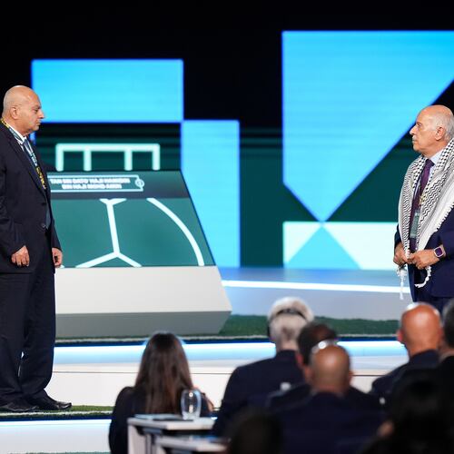 Palestinian Football Association President Jibril Rajoub, right, refuses to stand together with Israel Football Association Vice-President Basim Sheikh Suliman, left, after FIFA President Gianni Infantino, not seen, tried to bring them together during the 76th FIFA Congress in Vancouver, British Columbia, Thursday, April 30, 2026. (Darryl Dyck/The Canadian Press via AP)