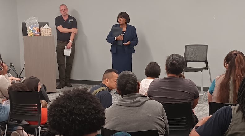 Gayle Holloman, Fulton County Library System executive director, announces a partnership with three Atlanta-area attractions to offer free passes to library cardholders. Dustin Landrum of the Georgia Public Library Service stands at left.