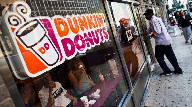 NEW YORK, NY - JULY 11: A customer enters a Dunkin' Donuts store in midtown Manhattan on July 11, 2011 in the New York City. Dunkin' Brands Group Inc., the parent of Dunkin' Donuts, plans to raise as much as $401 million by selling its initial public offering of 22.3 million shares, which are expected to fetch between $16 and $18. (Photo by Ramin Talaie/Getty Images)