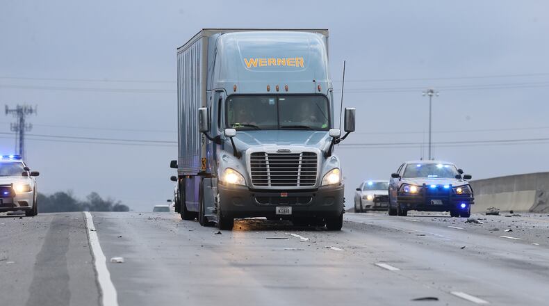 January 7, 2017, Covington: A tractor trailer truck slowly makes itâs way across a icy bridge overpass where a multi-vehicle accident on I-20 West at Alcovy Road had blocked all lanes as temperatures drop below freezing on Saturday, Jan. 7, 2017, in Covington. Curtis Compton/ccompton@ajc.com