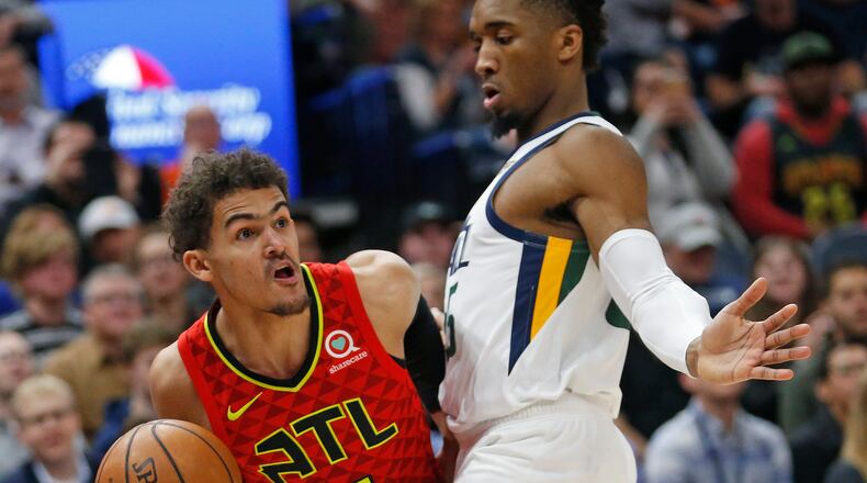 Utah Jazz guard Donovan Mitchell, right, guards Atlanta Hawks guard Trae Young during the first half of an NBA basketball game Friday, Feb. 1, 2019, in Salt Lake City. (AP Photo/Rick Bowmer)