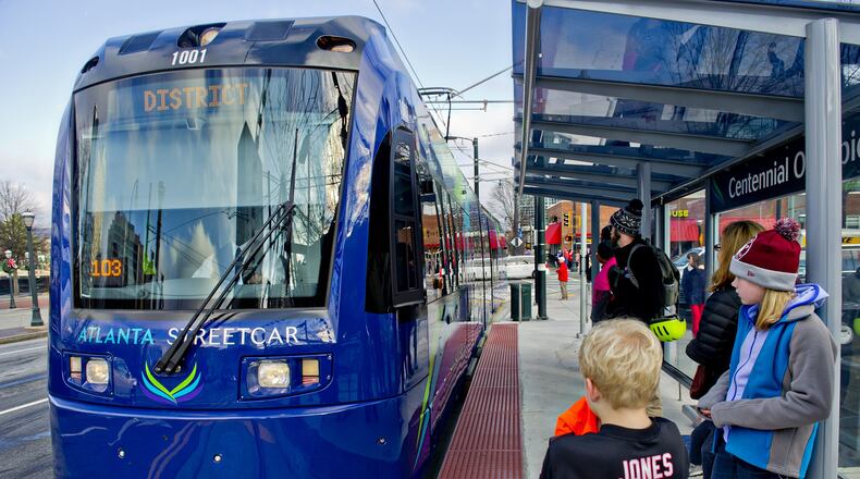December 31, 2014 Atlanta - Shelby Jones (right) and her brother Dalton wait at the Centennial Olympic Park stop as an Atlanta Streetcar pulls up on Wednesday, December 31, 2014. Each streetcar can hold up to 200 riders. The new service takes about 30 minutes to make a round trip for each of the 12 stops. JONATHAN PHILLIPS / SPECIAL