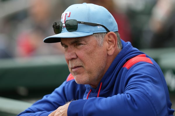 Texas Rangers manager Bruce Bochy pauses in the dugout during the second inning of a spring training baseball game against the San Francisco Giants, Thursday, March 13, 2025, in Scottsdale, Ariz. (AP Photo/Ross D. Franklin)