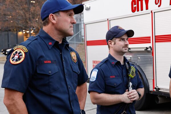 Sgt. Chris Moss (left) and firefighter Tyler Ross helped rescue two children from a stalled elevator inside the Ascent Peachtree complex earlier this month. (Natrice Miller/AJC)