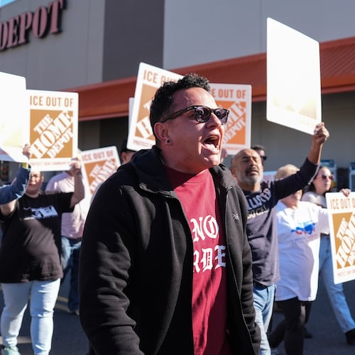 Organizing director for the National Day Laborer Organizing Network Jorge Torres, center, marches alongside protestors outside of a Home Depot, Wednesday, Nov. 19, 2025, in Charlotte, N.C. (AP Photo/Matt Kelley)
