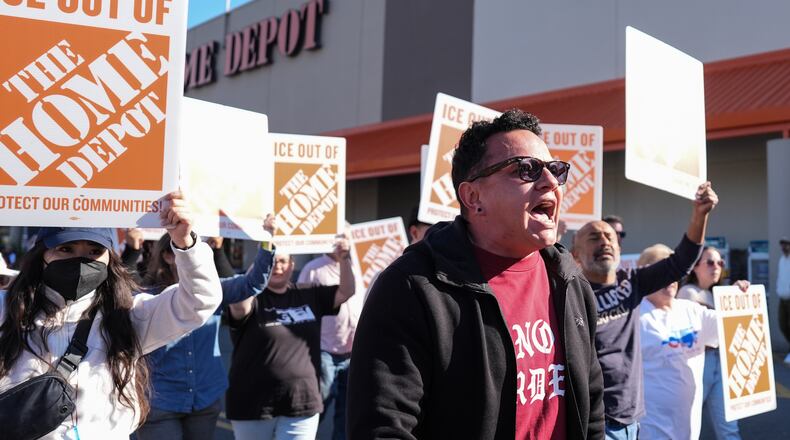 Organizing director for the National Day Laborer Organizing Network Jorge Torres, center, marches alongside protestors outside of a Home Depot, Wednesday, Nov. 19, 2025, in Charlotte, N.C. (AP Photo/Matt Kelley)