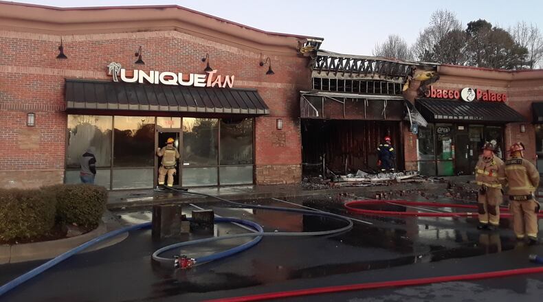The blaze destroyed a business and damaged three others.