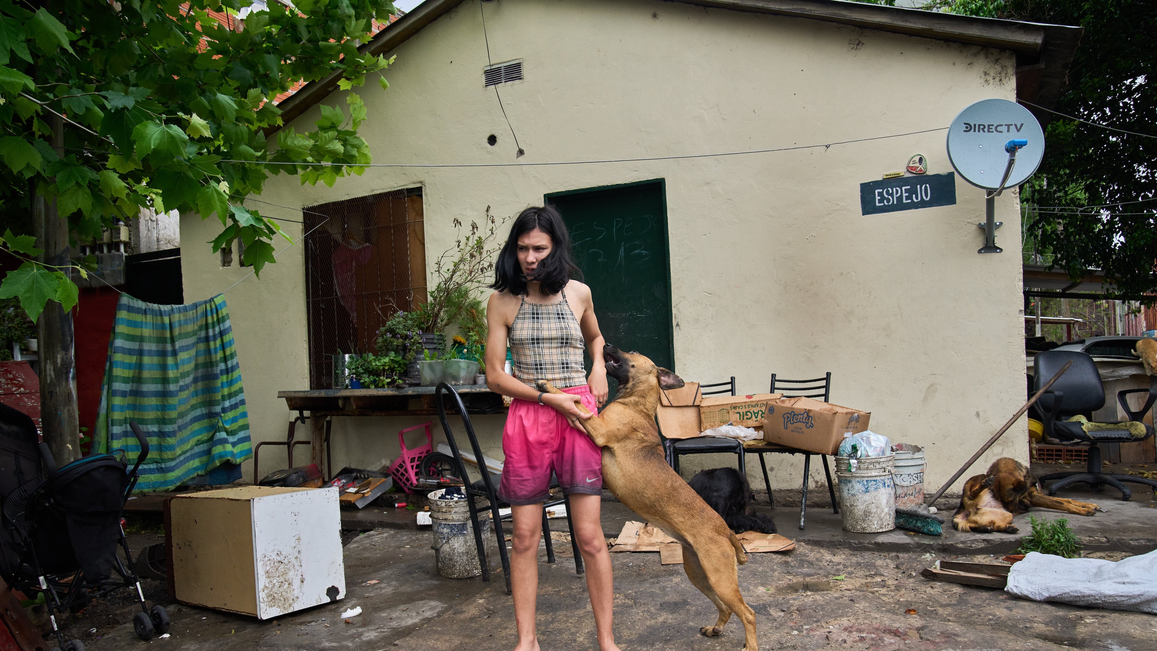 Abigail Rodriguez stands outside her home in the Isla Maciel neighborhood of Buenos Aires, Argentina, Friday, Oct. 24, 2025. (AP Photo/Rodrigo Abd)