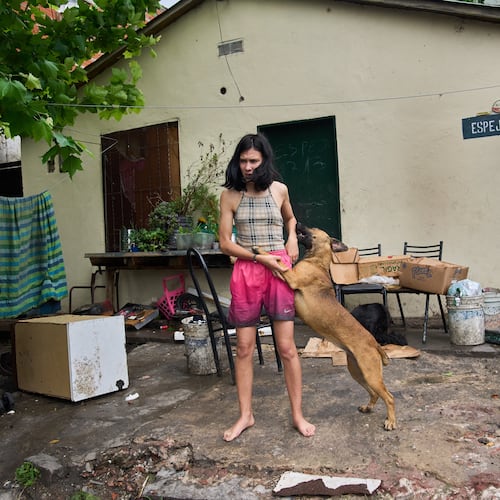 Abigail Rodriguez stands outside her home in the Isla Maciel neighborhood of Buenos Aires, Argentina, Friday, Oct. 24, 2025. (AP Photo/Rodrigo Abd)