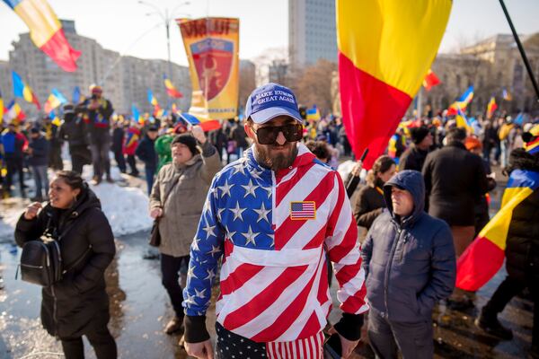 FILE - A man wears a U.S. flag themed outfit and a cap that reads "Make Europe Great Again" while taking part in a protest by supporters of Calin Georgescu, in Bucharest, Romania, Feb. 22, 2025. (AP Photo/Vadim Ghirda, File)