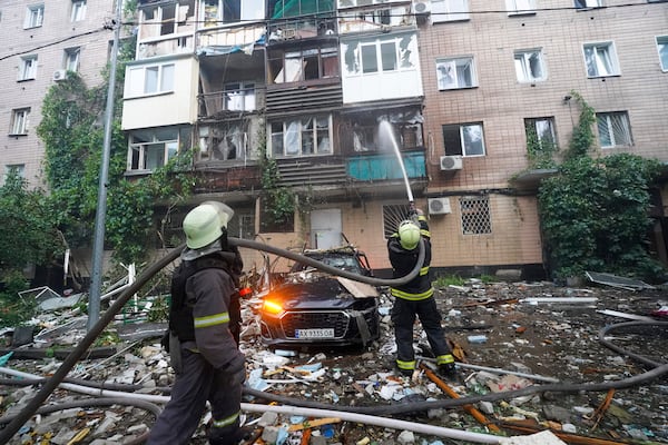 Firefighters tackle a blaze after a Russian attack that hit a residential building in Kharkiv, Ukraine, Saturday, June 7, 2025. (AP Photo/Andrii Marienko)