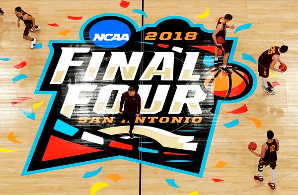 Loyola-Chicago head coach Porter Moser, center, walks on the court during a practice session for the Final Four NCAA college basketball tournament, Friday, March 30, 2018, in San Antonio. (AP Photo/Morry Gash)